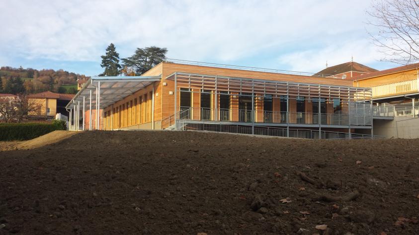 Bâtiment avec isolation extérieure finition bardage bois et enduit. 