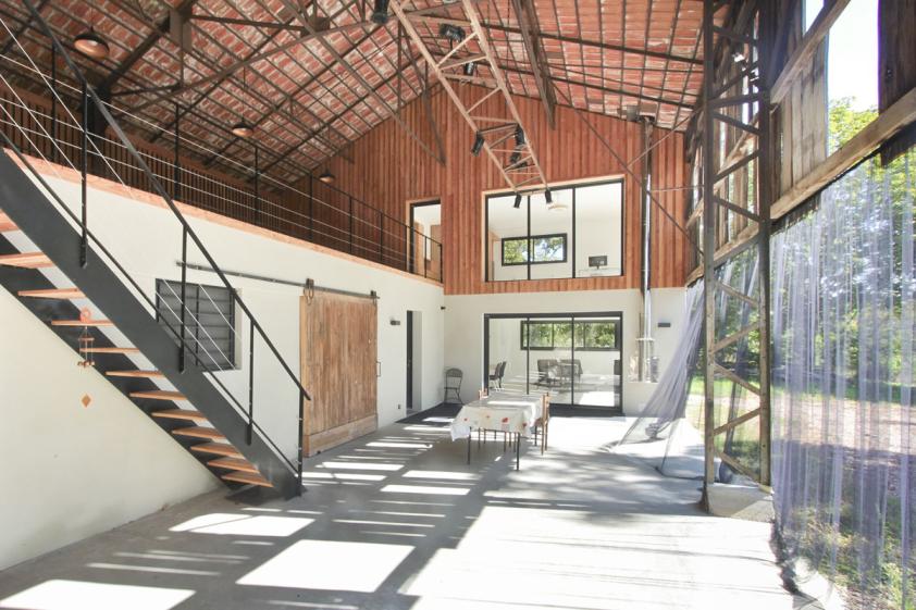 Transformation d'un hangar en maison > Vue de la façade intérieure créée sur la terrasse couverte