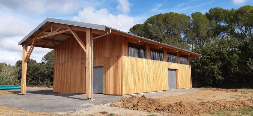 Façades ouest et sud avec préau. Construction bois.