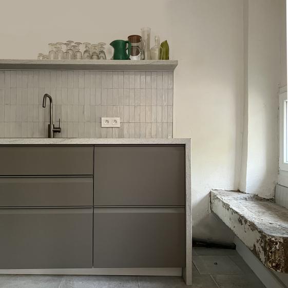 La cuisine, avec sa cheminée en pierre a été aménagée de manière contemporaine et pratique. 