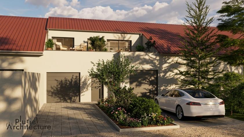Façade principale d’un bâtiment réhabilité en habitation avec création d’une entrée et d’une terrasse en toiture en Moselle