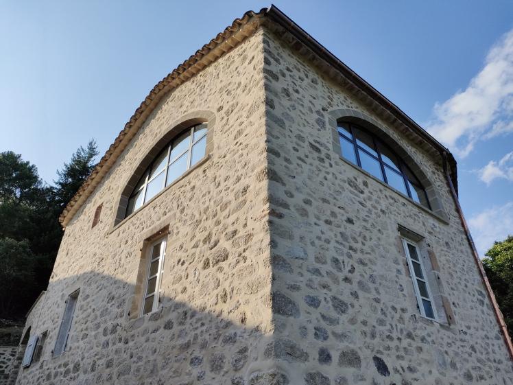 Façade – Ouvertures cintrées Création d’ouvertures cintrées et travail de la façade en pierre, participant à la recomposition des volumes.