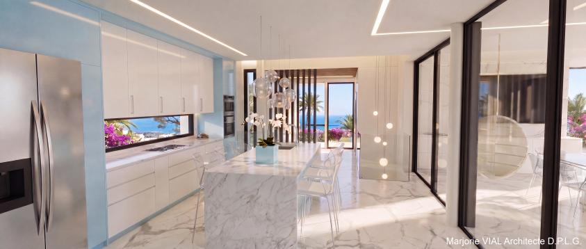 Maison contemporaine haut de gamme d'une surface de plancher de 230 m². Volume épuré en maçonnerie blanche. Revêtement de sol, îlot central et plan de travail de la cuisine en marbre blanc.