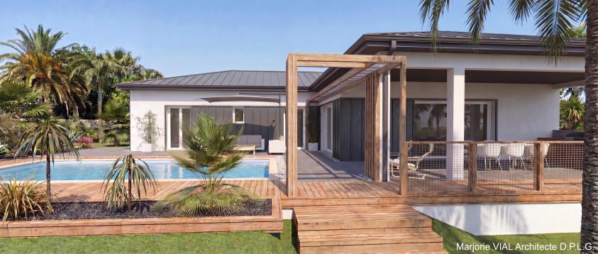Vue de la maison depuis le jardin Modernisation des façades (bardage métallique sombre, rampes d'éclairage, et brise-soleil métalliques), décor en bois de connexion au jardin (marches et portique d'accès, jardinières filantes et garde-corps en filet)