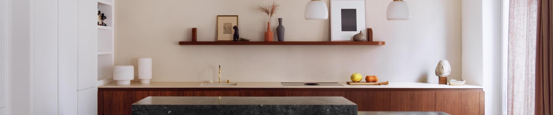 cuisine ouverte sur la pièce de vie séparée par un ilôt sculptural en marbre vert, rénovation d'un appartement haussmannien