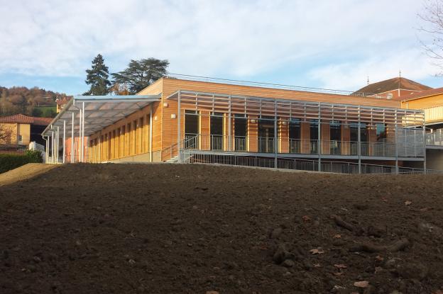 Bâtiment avec isolation extérieure finition bardage bois et enduit. 
