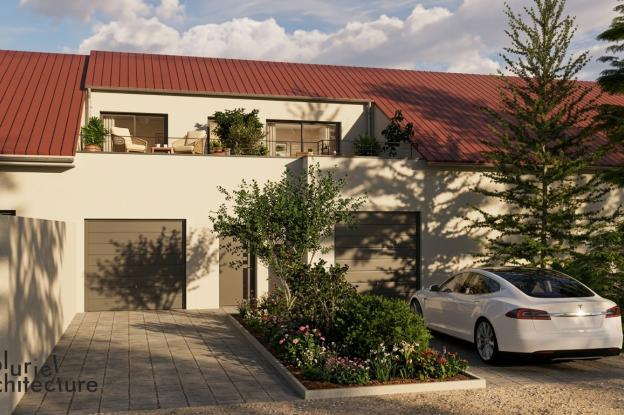 Façade principale d’un bâtiment réhabilité en habitation avec création d’une entrée et d’une terrasse en toiture en Moselle
